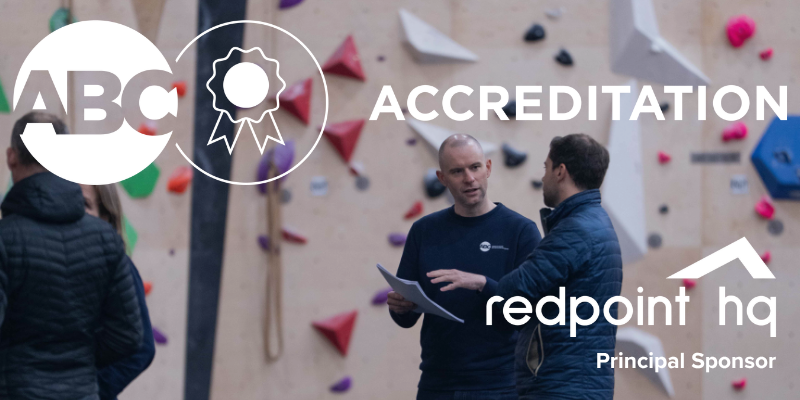 ABC Accreditation Logo with Redpoint HQ logo and the text 'Principal Sponsor'. The background image is two men at a climbing wall looking at a paper document.